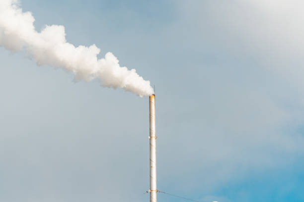 istock Pipe and smoke.Polluting air with white smoke from industrial chimney outdoors. CO2 emissions.Copy space. 2045029199