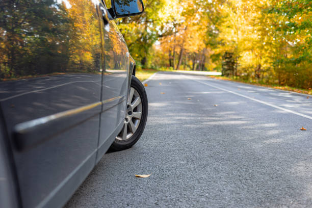 istock Car on asphalt road on autumn day at forest or park.Selective focus,copy space. 2045046469