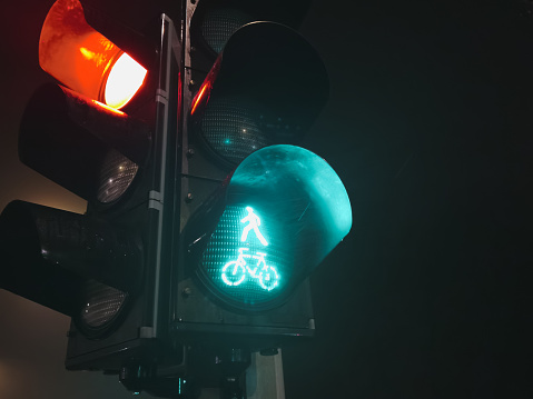 Traffic control, traffic light with green light at night. High quality photo