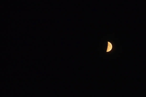 One half moon in the dark sky.Night Evening Sky Blue Moon.Copy space.Soft focus.Blurred image.