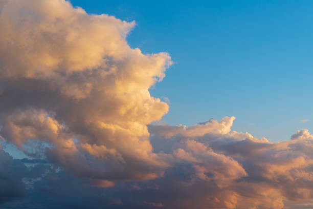 Beautiful sunset evening orange, yellow and dark murky clouds.Sunset evening cloud,golden cloud.Nice background.