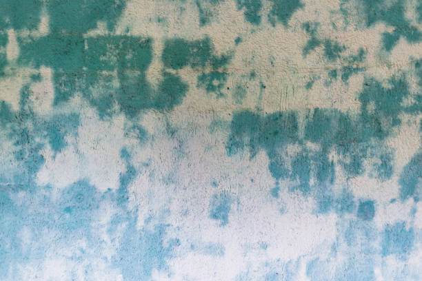 Blue green spoted exposed wall texture.Empty old stained art texture of plaster brick wall background.