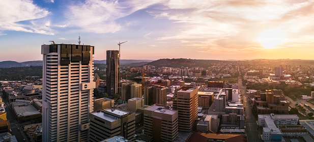 Sunrise over Pretoria city centre with construction upgrading to the South African Reserve Bank building in the centre.