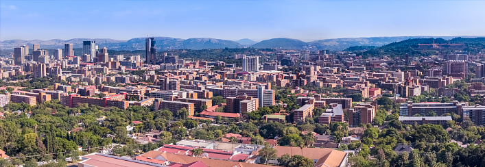 Pretoria / Tshwane cityscape panorama with the surrounding Magaliesburg mountain range.