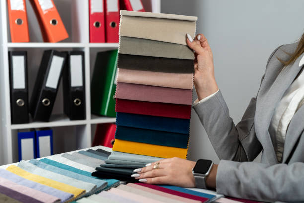 istock close up female designer hand choosing fabric among colorful samples at office 2045103583