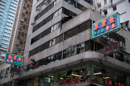 Neon Placards on an old building in Mong Kok district, Kowloon peninsula, Hong Kong
