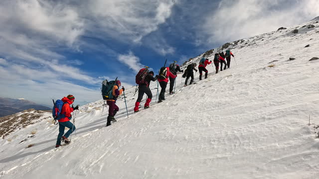 Mountain climber team is walking on the mountain while watching  the beautiful landscape of  mountain summit.