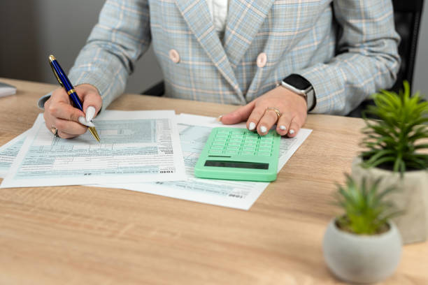 istock Female accountant work with 104 tax form at office. Audit concept 2045116436