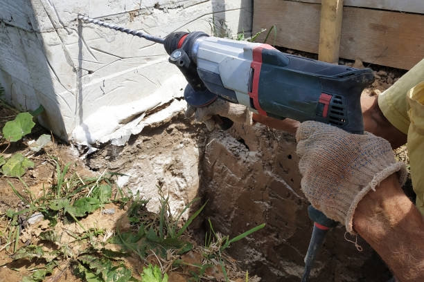 istock Drilling a hole in the concrete wall with a jackhammer, perforator in operation. 2045125987