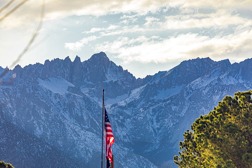 Aerial ahot of a US flag waving over a freeway at a truck stop near Salome in Arizona.