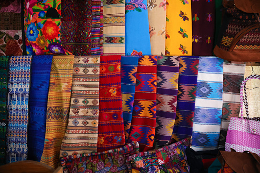Colorful fabrics for sale at a local market in the old town of Antigua, Guatemala.