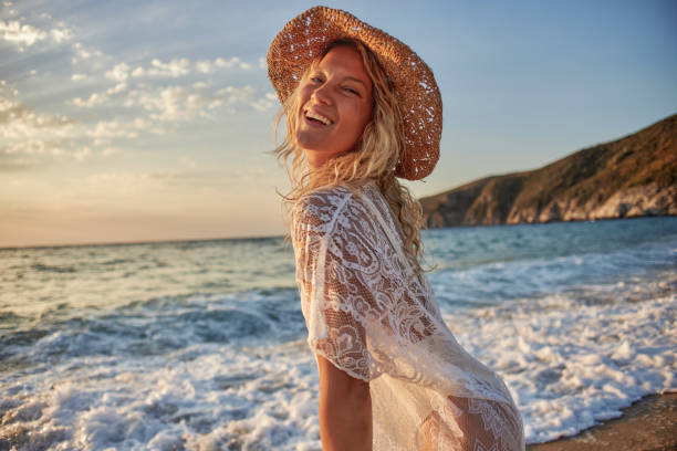 istock Beautiful woman running inside water on the beach at sunset 2045163573