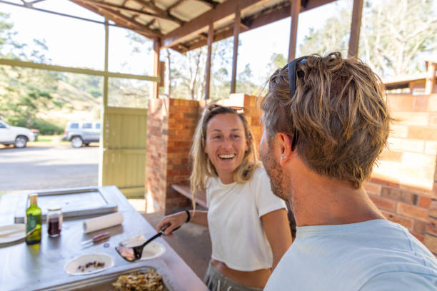 istock Culinary Bliss: Young Couple's Joyful BBQ Experience with Her at the Helm 2045165671