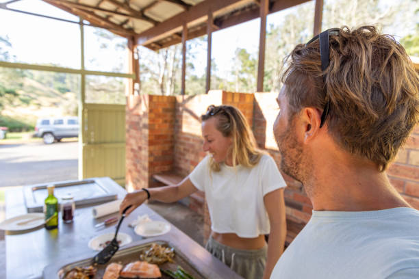 istock Sizzling Romance: Young Couple's Culinary Delight at the Outdoor Barbecue 2045165734