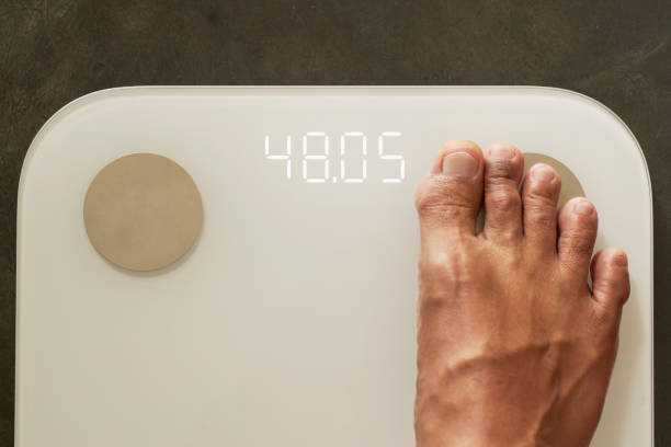 istock The right foot is standing on the body scale 2045177890