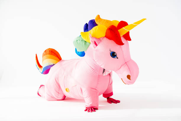 istock Pink unicorn inflatable costume kneeling on floor 2045185337