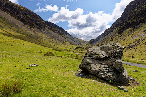 A massive slate boulder sits in the valley at Honister Pass Cumbria England UK