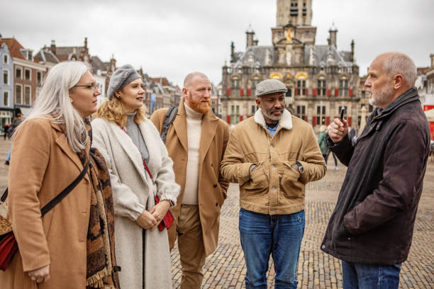 istock Two middle aged diverse couples on staycation in Delft with a tour guide 2045200311