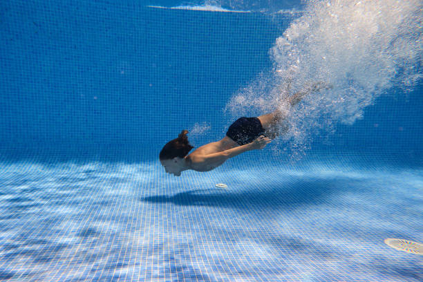 Carefree boy swimming in pool