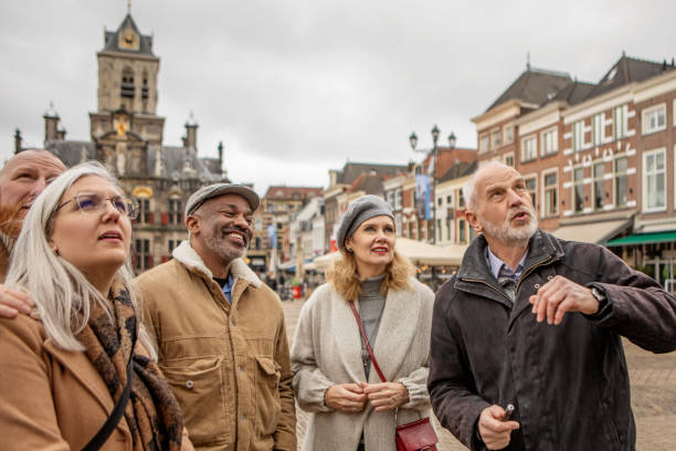 Two middle aged diverse couples on staycation in Delft with a tour guide