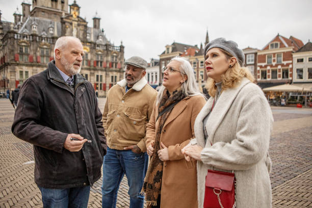 istock Two middle aged diverse couples on staycation in Delft with a tour guide 2045204114