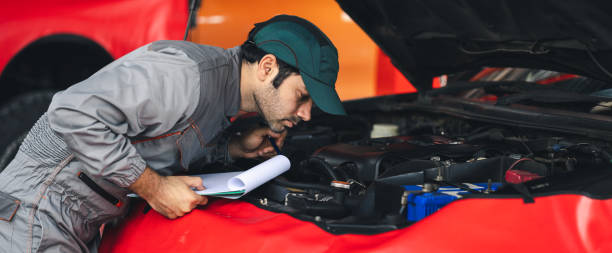 istock Panoramic professional automobile maintenance checking car damage broken part condition with using clipboard. Diagnostic and repairing vehicles at garage automotive. 2045212338