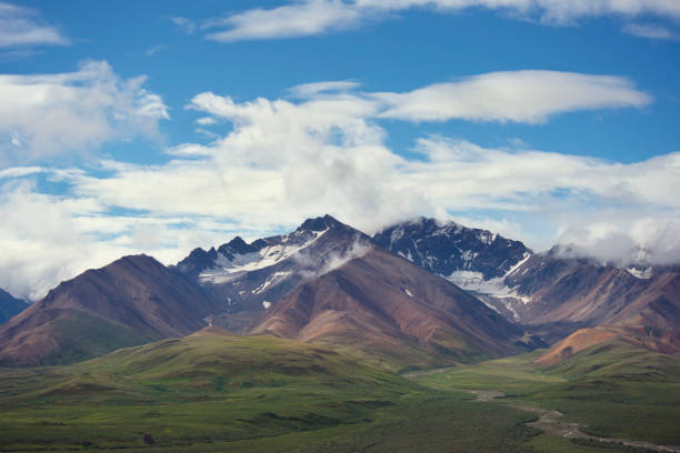 Alaska Landscape with Snowy Mountains and Cloudy sky.