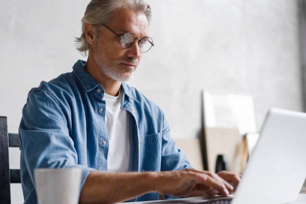 istock Middle-aged man working from home-office on laptop. 2045223612