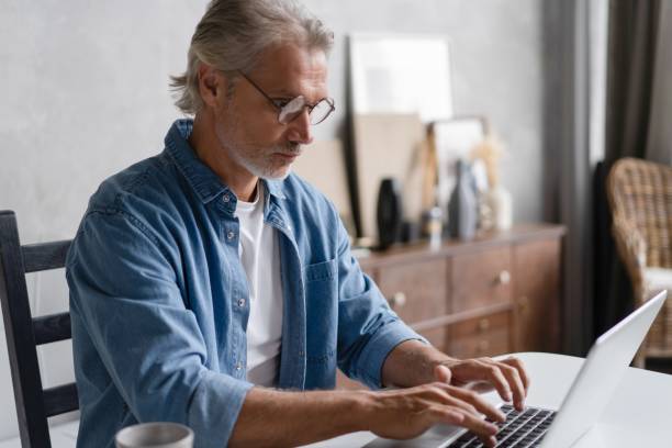 istock Middle-aged man working from home-office on laptop. 2045223614