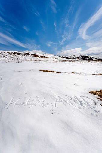 The word Iceland written on the snow.