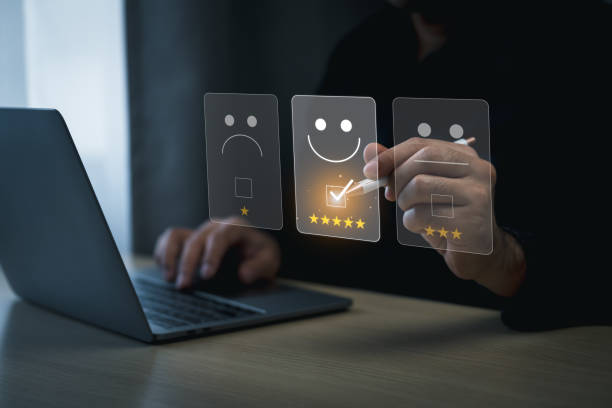 istock Customer Satisfaction Rating with Digital Interface. Businessman use laptop and digital pen selecting a glowing five-star rating on a virtual interface with smile emotion emoticon feedback options. 2045257630