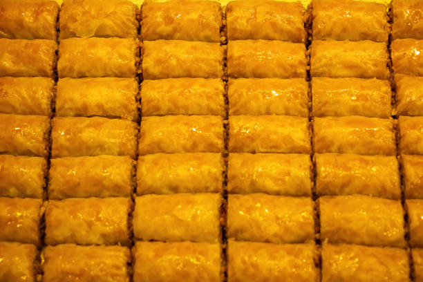 A tray of baklava sitting on the counter of a dessert shop.