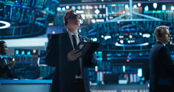 istock Portrait of a Successful Stock Exchange Manager Working in a Modern Office. Proactive Trader Browsing Internet on a Tablet Computer, Using Software with Online Stock Market Data Prediction 2045272078