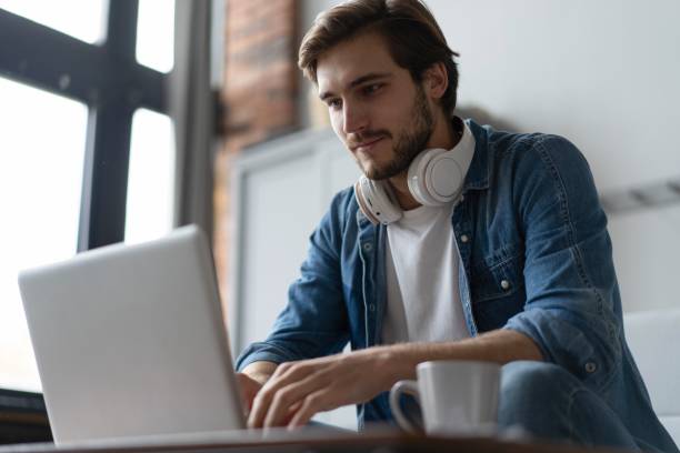 istock Businessman working with laptop from home sitting at table. 2045284976