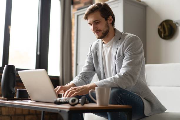 istock Businessman working with laptop from home sitting at table. 2045284990