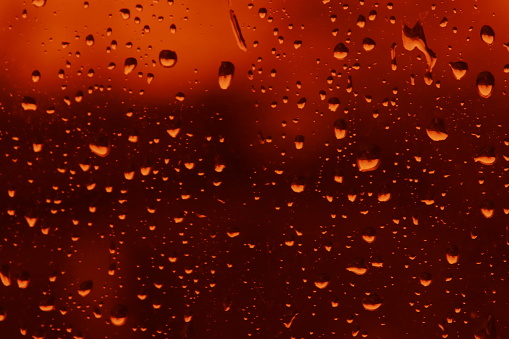 Raindrops on red glass