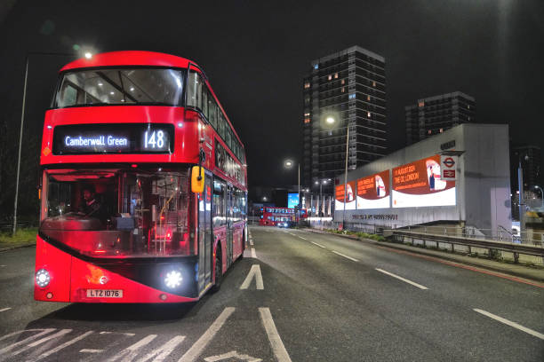London, UK -  January 04, 2016: London bus at night travelling along Bath Road in Hounslow, West London. The driver and passengers are visible on the bus.