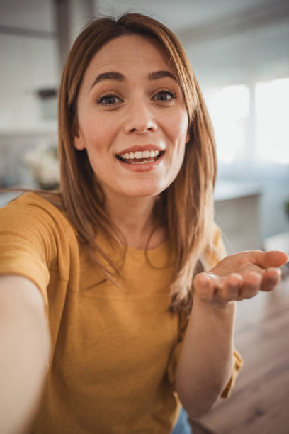 istock A beautiful young woman, a social media influencer, is making a video 2045338917