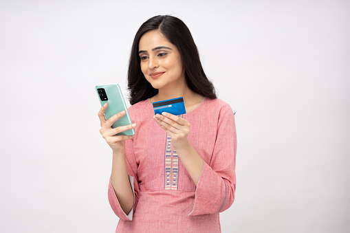 Portrait of Indian young woman wearing casual kurta on white background