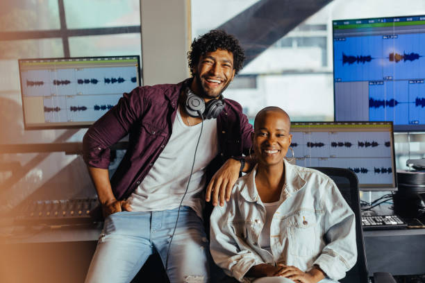 istock Happy sound engineers in recording studio with audio editing software 2045382868