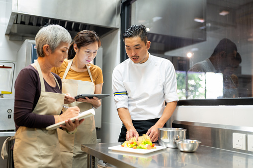 Adults learning from professional chef