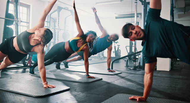 Personal trainer, gym class and plank for exercise, training and core muscle strength for healthy body. Wellness, workout and power for performance, challenge and fitness club for commitment