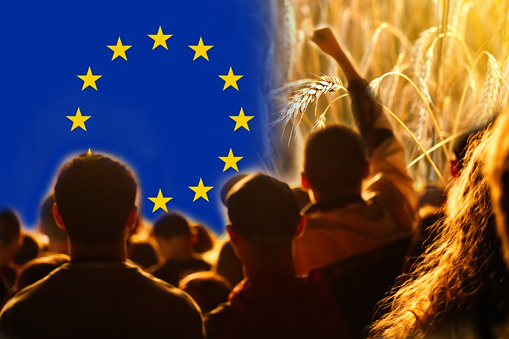 Farmers protest in Europe. Flag, wheat and people background. Farmers' protests in Europe.