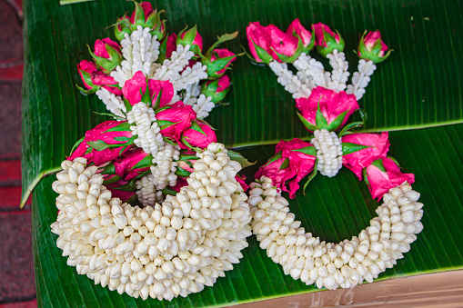 Thai style flower garland made of jasmine, marigold, crown flower and rose.