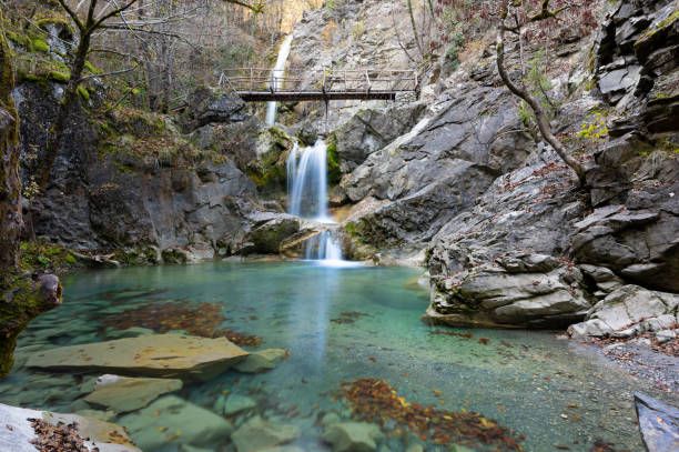 Waterfall in Greece View of the Balta di Stringa waterfall near the village of Iliochori at the area of Zagori in Epirus, Greece zagori stock pictures, royalty-free photos & images