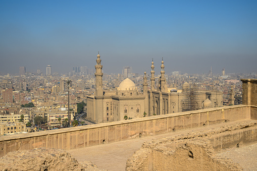 View of the city of Cairo from the wall surrounding the Citadel. A mosque with minarets is in the foreground.