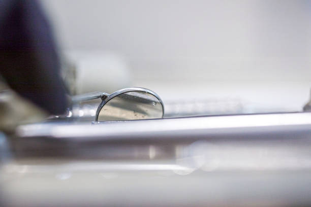 dentist put a dental mirror on the table while treating and restoring teeth.