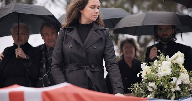 usa veteran funeral, woman and sad to touch casket, family and flag with mourning, depression and respect. widow, people and army service with coffin, burial and crying for war hero in philadelphia - child grief mourner disappointment zdjęcia i obrazy z banku zdjęć