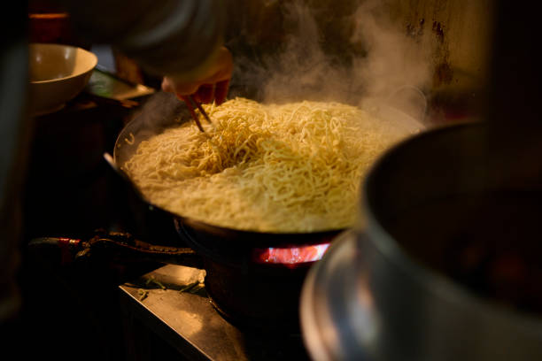 An old skilled chef made Stir-Fried mud eel noodles. Taiwanese traditional famous and delicious street food in Taiwan, traditional cuisine in Taiwan. Close up of top view Chinese style food, usually can be founded in night market. Tainan, Taiwan.