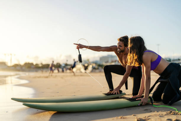 istock Surfers are pointing and looking at waves. 2045431764